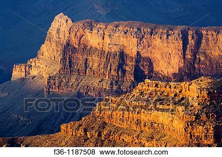 Stock Photo - Sunrise light on red rock cliff formations below the North Rim at Point Sublime, Grand Canyon National Park, Arizona. Fotosearch