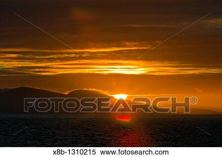 Stock Photography - Sunrise on Carcass Island in the Falkland Islands, South Atlantic Ocean. Fotosearch