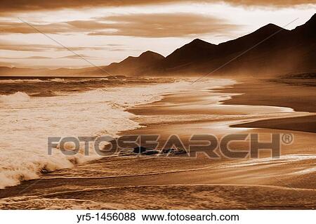 Stock Photo - Sunrise over Cofete beach on the south west coast of Fuerteventura, Canary Islands, Spain. Fotosearch