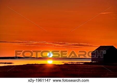 Sunrise over salt pond with boat house silhouette, Eastham, Cape Cod, MA, USA. View Large Photo Image Stock Photo - Sunrise over salt pond with boat house silhouette, Eastham, Cape Cod, MA, USA.. Fotosearch