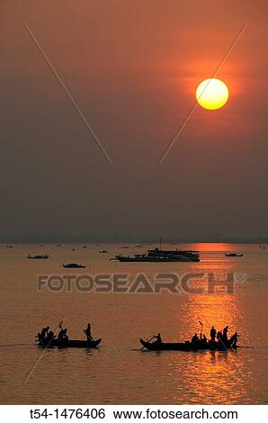 Stock Photograph - Sunrise over the Mekong River at Phnom Penh. Fotosearch