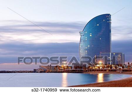 sunrise view of W Hotel Barcelona, Barceloneta Beach, Barcelona, Catalonia, Spain View Large Photo Image Stock Photo - sunrise view of W Hotel Barcelona, Barceloneta Beach, Barcelona, Catalonia, Spain. Fotosearch