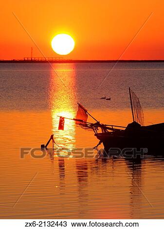 Sunrise with pergola of Trabucador Peninsula at Alfacs Bay. Ebro River Delta Natural Park, Tarragona province, Catalonia, Spain. View Large Photo Image Stock Image - Sunrise with pergola of Trabucador Peninsula at Alfacs Bay. Ebro River Delta Natural Park, Tarragona province, Catalonia, Spain.. Fotosearch
