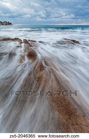 Sunrise with rocks and waves at cala baladrar in benissa, alicante, comunidad valenciana, spain, europe. View Large Photo Image Stock Photography - Sunrise with rocks and waves at cala baladrar in benissa, alicante, comunidad valenciana, spain, europe.. Fotosearch