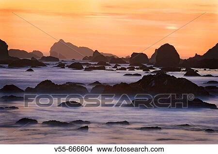 Sunset and misty waves breaking on beach in Crescent City, California. USA View Large Photo Image Picture - Sunset and misty waves breaking on beach in Crescent City, California. USA. Fotosearch