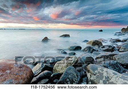 Sunset and storm clouds over Pegasus Bay near Christchurch, New Zealand View Large Photo Image Stock Photograph - Sunset and storm clouds over Pegasus Bay near Christchurch, New Zealand. Fotosearch