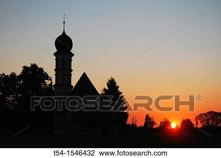 Stock Image - Sunset at a chapel. Fotosearch