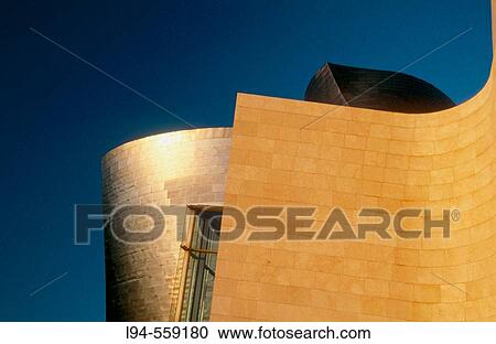 Stock Image - Sunset at Guggenheim Museum, by Frank O. Gehry. Bilbao. Spain. Fotosearch
