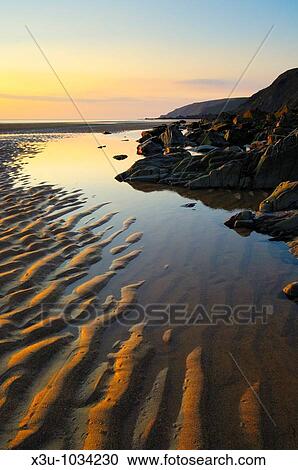 Stock Image - Sunset at Sandymouth beach, Cornwall, England. Fotosearch