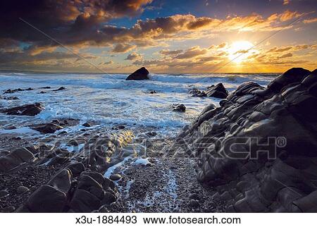 Stock Image - Sunset at Sandymouth Beach on the North Atlantic coast near Bude in Cornwall, England, United Kingdom. Fotosearch