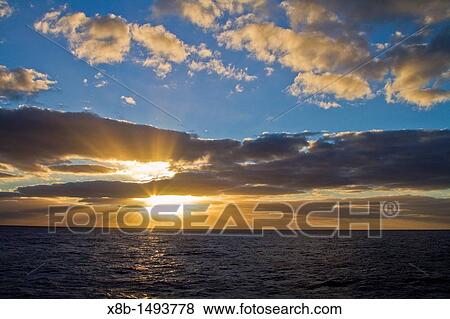 Sunset at sea near Nightingale Island, part of the Tristan da Cunha Group, South Atlantic Ocean View Large Photo Image Stock Photo - Sunset at sea near Nightingale Island, part of the Tristan da Cunha Group, South Atlantic Ocean. Fotosearch