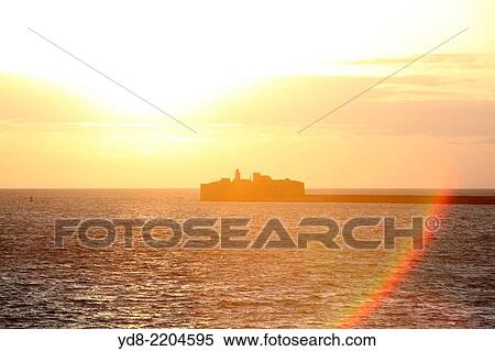 Sunset at the output of the industrial port of Cherbourg in France View Large Photo Image Stock Photography - Sunset at the output of the industrial port of Cherbourg in France. Fotosearch