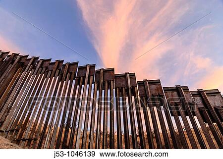 Sunset at United States border fence, US/Mexico border, east of Nogales, Arizona, USA View Large Photo Image Stock Photo - Sunset at United States border fence, US/Mexico border, east of Nogales, Arizona, USA. Fotosearch
