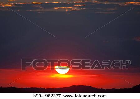 SUNSET BELOW STORM CLOUD OVER LAND. View Large Photo Image Stock Photo - SUNSET BELOW STORM CLOUD OVER LAND.. Fotosearch