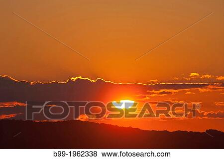 SUNSET CLOUDS OVER LAND. View Large Photo Image Stock Photo - SUNSET CLOUDS OVER LAND.. Fotosearch