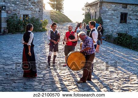 Sunset in the village of Cebreiro while a group plays the bagpipes. View Large Photo Image Stock Image - Sunset in the village of Cebreiro while a group plays the bagpipes.. Fotosearch