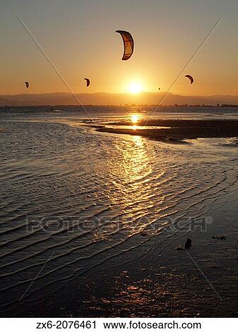 Sunset kitesurfing at Alfacs Bay. Ebro River Delta Natural Park, Tarragona province, Catalonia, Spain. View Large Photo Image Stock Image - Sunset kitesurfing at Alfacs Bay. Ebro River Delta Natural Park, Tarragona province, Catalonia, Spain.. Fotosearch