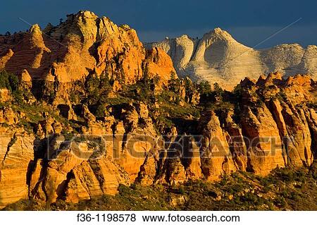Sunset light through storm clouds on red rock cliffs near Lee Valley, Kolob Section, Zion National Park, Utah View Large Photo Image Stock Photo - Sunset light through storm clouds on red rock cliffs near Lee Valley, Kolob Section, Zion National Park, Utah. Fotosearch