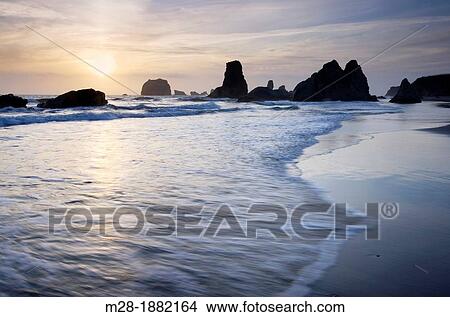 Sunset on Bandon Beach and Bandon Pinnacles, Bandon Oregon View Large Photo Image Picture - Sunset on Bandon Beach and Bandon Pinnacles, Bandon Oregon. Fotosearch