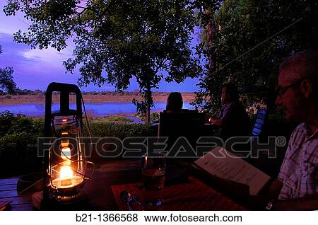 Sunset on the Okavango river at? Crocodile Lodge?, Maun, Botswana View Large Photo Image Stock Photo - Sunset on the Okavango river at? Crocodile Lodge?, Maun, Botswana. Fotosearch