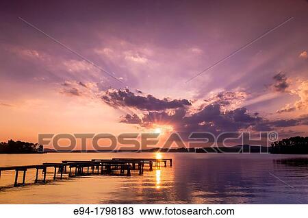 Sunset over a lake with a small boat dock silhouetted in the foreground, Lake Guntersville State Park, Alabama, USA. View Large Photo Image Stock Image - Sunset over a lake with a small boat dock silhouetted in the foreground, Lake Guntersville State Park, Alabama, USA.. Fotosearch