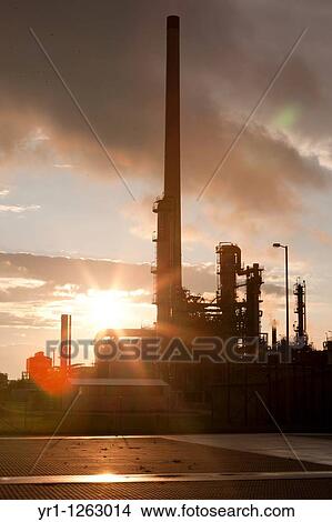Picture - Sunset over an oil refinery in germany.. Fotosearch