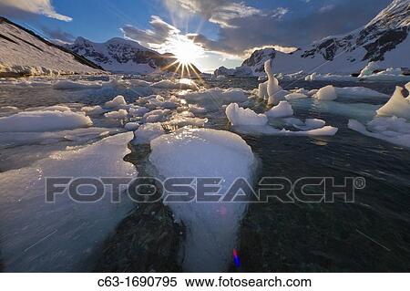Sunset over bergy-bits of ice off the shore of Danco Island, Antarctica View Large Photo Image Stock Photography - Sunset over bergy-bits of ice off the shore of Danco Island, Antarctica. Fotosearch