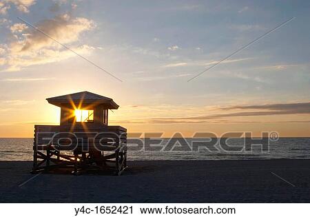 Stock Image - SUNSET OVER GULF OF MEXICO AT VENICE BEACH IN VENICE FLORIDA. Fotosearch