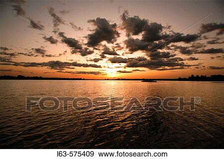 Stock Photo - Sunset over Lake of Tengrela. Banfora area, Burkina Faso. Fotosearch