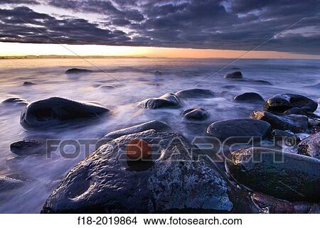 Sunset over rocky coast line, Sumner beach, Christchurch, New Zealand. View Large Photo Image Picture - Sunset over rocky coast line, Sumner beach, Christchurch, New Zealand.. Fotosearch