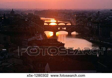 Stock Image - Sunset over the Arno river with bridges, Florence, Tuscany, Italy. Fotosearch