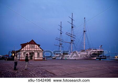 sunset over the harbor and the three-mast barque Gorch Fock 1 in the Hanseatic City of Stralsund, Mecklenburg-Vorpommern, Germany View Large Photo Image Stock Photograph - sunset over the harbor and the three-mast barque Gorch Fock 1 in the Hanseatic City of Stralsund, Mecklenburg-Vorpommern, Germany. Fotosearch