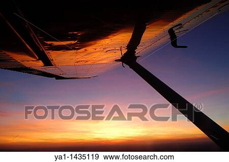 Sunset reflection on Cessna 172 wing during a flight over Luxembourg country View Large Photo Image Stock Photo - Sunset reflection on Cessna 172 wing during a flight over Luxembourg country. Fotosearch