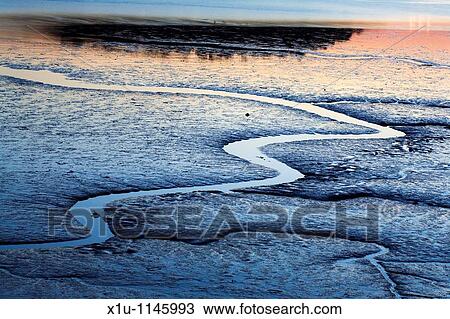Stock Image - Sunset Reflections in the Conway Estuary Conway Wales. Fotosearch