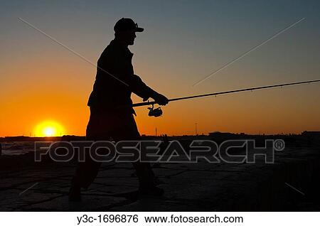 Sunset silhouette of Fisherman casting the fishing rod View Large Photo Image Stock Photograph - Sunset silhouette of Fisherman casting the fishing rod. Fotosearch