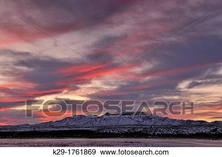 Stock Photo - Sunset skies over the Chupadera Mountains, Bosque del Apache NWR, New Mexico, USA. Fotosearch
