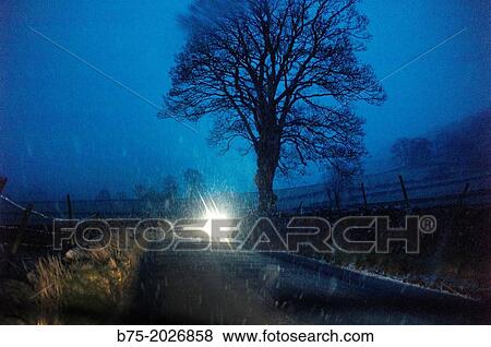 Sunset snowing on a road with a car in Yorkshire Dales, England, UK View Large Photo Image Stock Photo - Sunset snowing on a road with a car in Yorkshire Dales, England, UK. Fotosearch