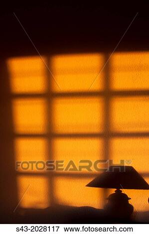 Sunset through a window reflect on a wall. View Large Photo Image Stock Photo - Sunset through a window reflect on a wall.. Fotosearch