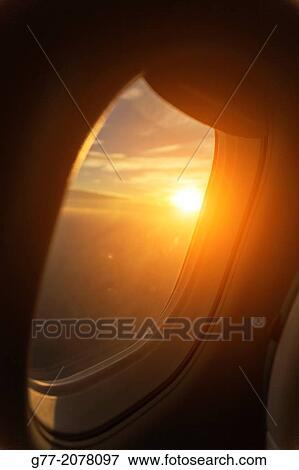 Stock Photo - Sunset view from airplane window.. Fotosearch