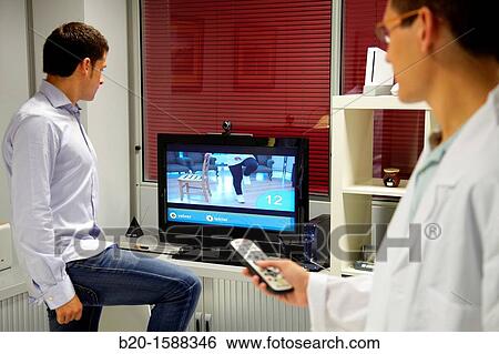 Stock Photograph - Supervision of rehabilitation exercises using videos. Fotosearch