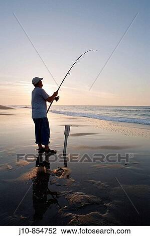 Surf-casting at sunrise, Outer Banks, Ocracoke Island, North Carolina, USA View Large Photo Image Stock Image - Surf-casting at sunrise, Outer Banks, Ocracoke Island, North Carolina, USA. Fotosearch