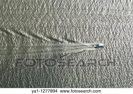 Picture - Surface waves created by a speed boat on Hudson river, New York, USA. Fotosearch