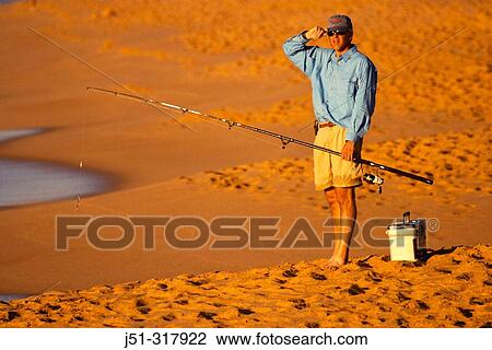 Surfcasting at Playa Solmar in early evening, beach, man hold fishing rod, tackle box on sand. Cabo San Lucas. Mexico View Large Photo Image Stock Image - Surfcasting at Playa Solmar in early evening, beach, man hold fishing rod, tackle box on sand. Cabo San Lucas. Mexico. Fotosearch