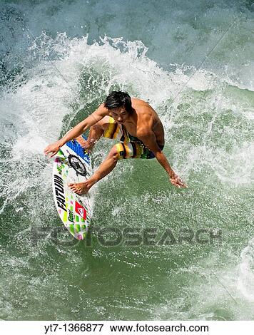 Surfer catching a wave View Large Photo Image Stock Photo - Surfer catching a wave. Fotosearch