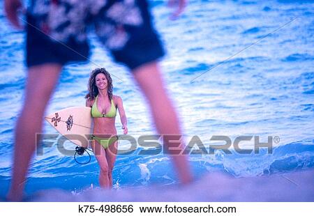 Stock Photograph - Surfer girl and surfer guy. Fotosearch
