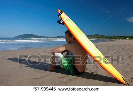 Surfer on Tamarindo beach in Costa Rica, Central America View Large Photo Image Stock Photography - Surfer on Tamarindo beach in Costa Rica, Central America. Fotosearch