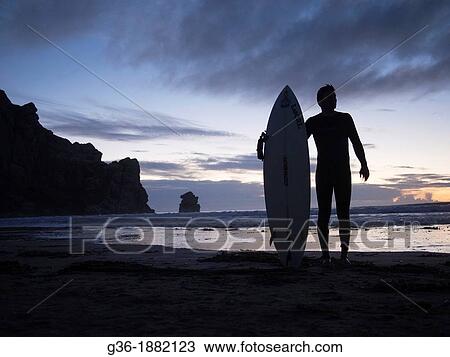 Surfer on the beach in Morro Bay, California View Large Photo Image Stock Image - Surfer on the beach in Morro Bay, California. Fotosearch