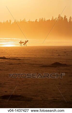 Stock Photo - Surfers on a beach, Vancouver Island, British Columbia, Canada. Fotosearch
