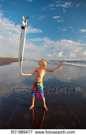 Stock Photo - Surfers on Playa Hermosa in Costa Rica, Central America. Fotosearch