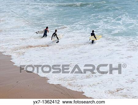 Stock Image - Surfers, Tarifa, Costa de la Luz, Cadiz province, Andalusia, Spain. Fotosearch